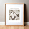 Framed watercolor painting of a Littmann stethoscope with information on it in an antique style