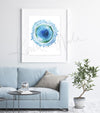 Framed watercolor painting of a B cell. The painting is hanging over a blue couch.