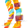 Zoomed in view of a watercolor painting of a spinal columns in yellow, orange, burgundy and teal.