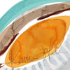 Zoomed in view of a contemporary poster design of the lens in teal, brown, orange, and gray.of the lens in teal, brown, orange, and gray.