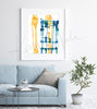 Framed watercolor painting of a post orthopedic surgery x-ray. The painting is hanging over a blue couch.