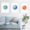 Framed watercolor painting set of t-cells. The painting is hanging over a blue couch.